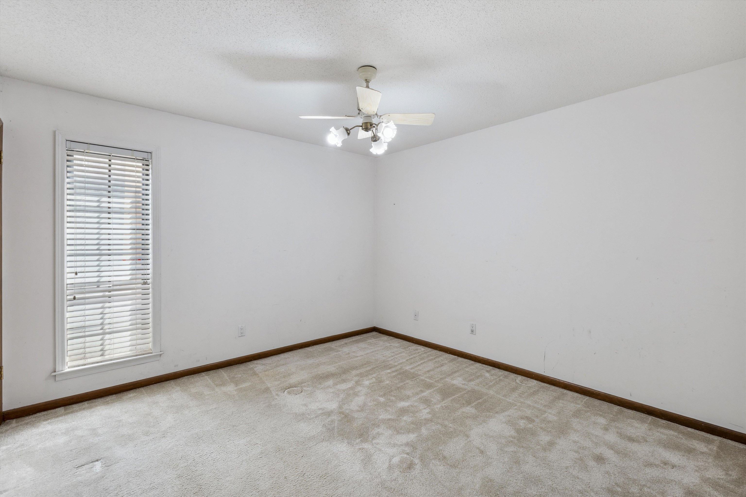 5973 Explorer Road Bartlett, TN 38134 - Photo 17 of 35 an empty room with a window and ceiling fan