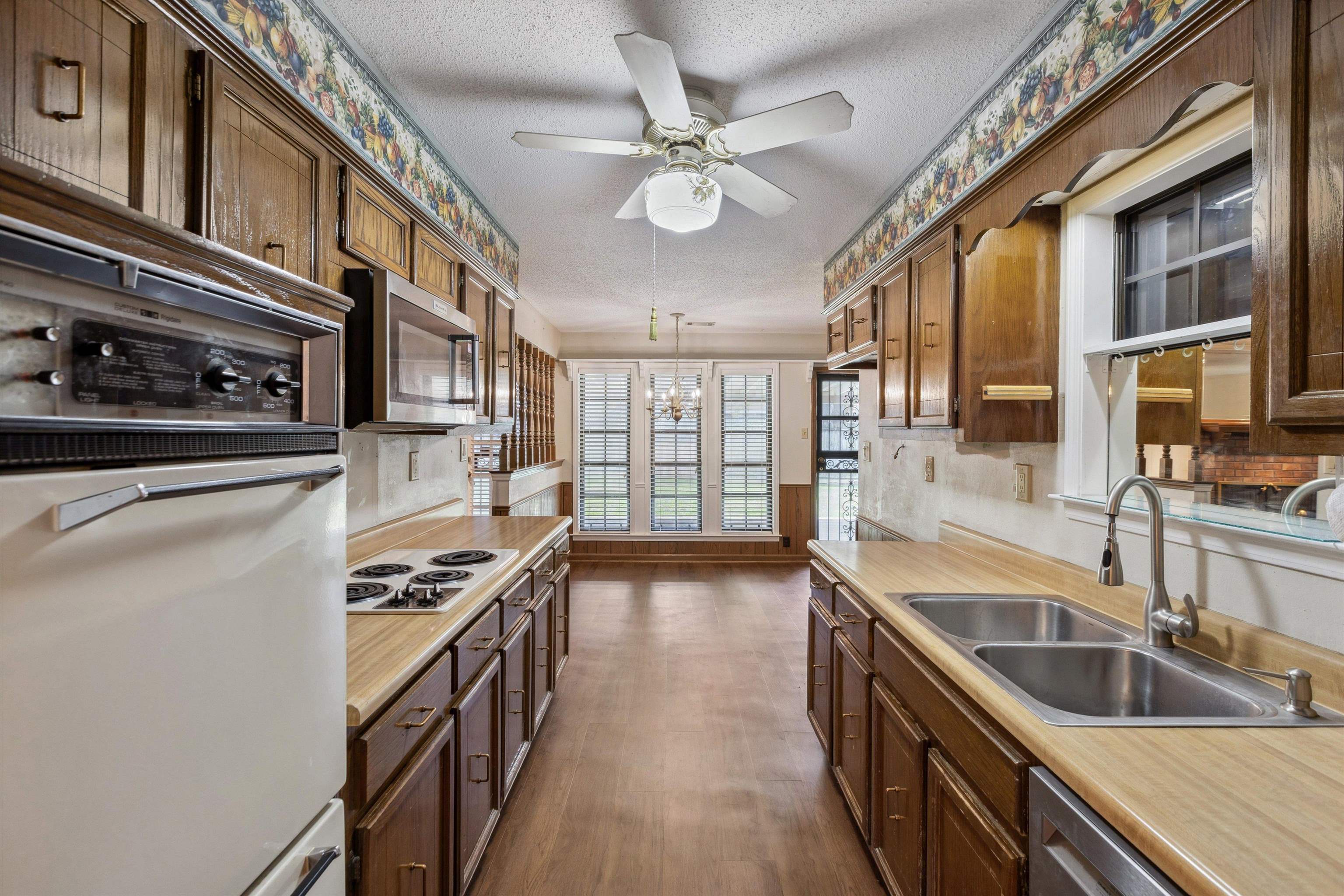 5973 Explorer Road Bartlett, TN 38134 - Photo 23 of 35 a kitchen with stainless steel appliances granite countertop a sink a stove and a refrigerator