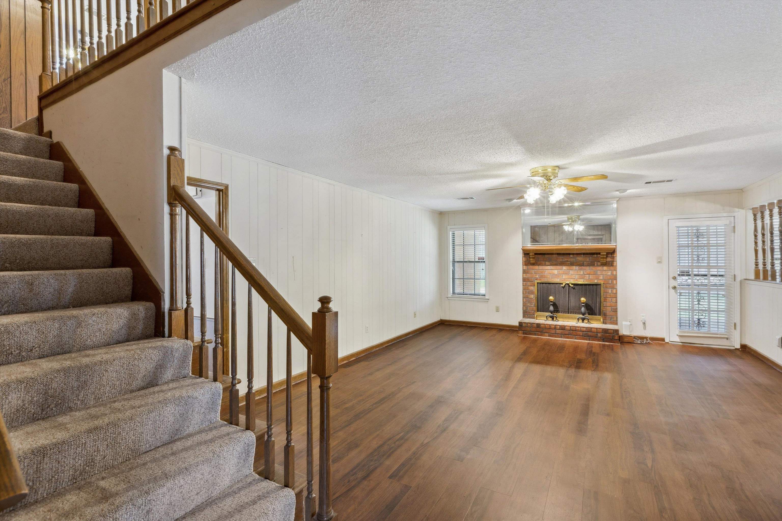 5973 Explorer Road Bartlett, TN 38134 - Photo 5 of 35 a view of a livingroom with wooden floor and a fireplace