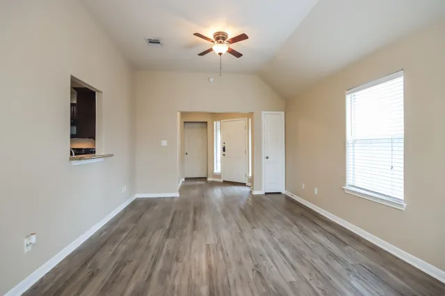 wooden floor in an empty room with a window