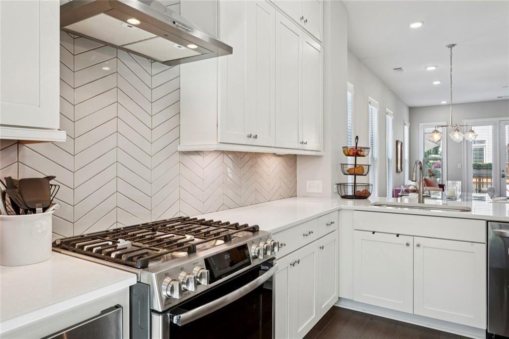 4219 Deming Circle Sandy Springs, GA 30342 - Photo 15 of 47 a kitchen with white cabinets and appliances