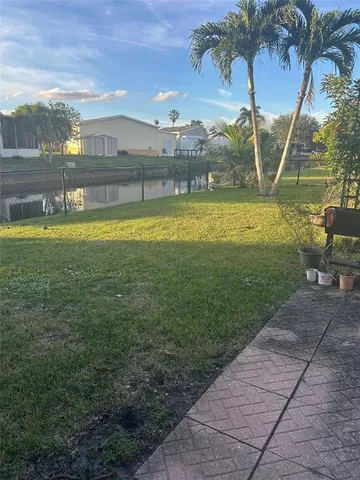a view of a swimming pool with a yard