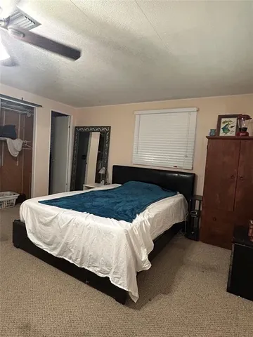 a bedroom with a bed and dresser