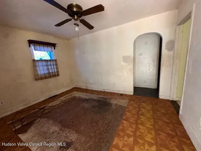 a view of a livingroom with a ceiling fan and wooden floor