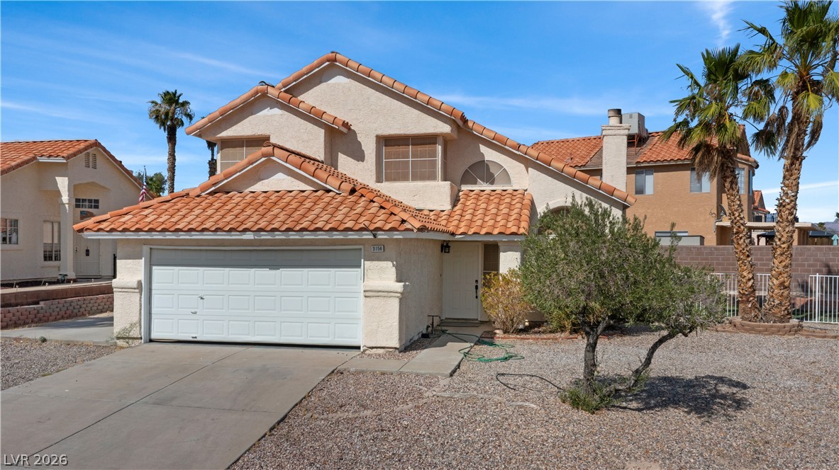 3156 Terrace View Drive Laughlin, NV 89029 - Photo 72 of 94 A well-maintained stucco residence offers a two-car garage, mature landscaping, and a classic tile roof.