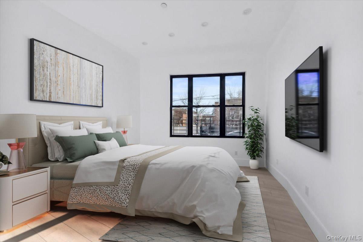 953 Tilden Street Bronx, NY 10469 - Photo 2 of 24 a bedroom with bed and a window