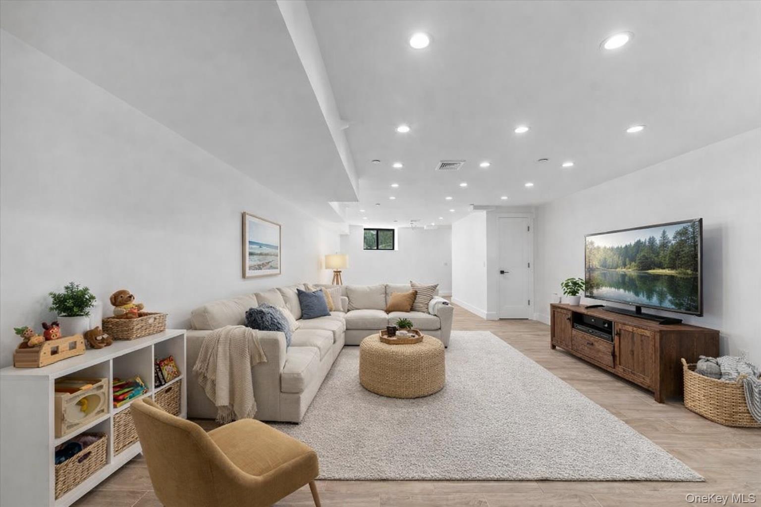 953 Tilden Street Bronx, NY 10469 - Photo 23 of 24 a living room with furniture and a flat screen tv