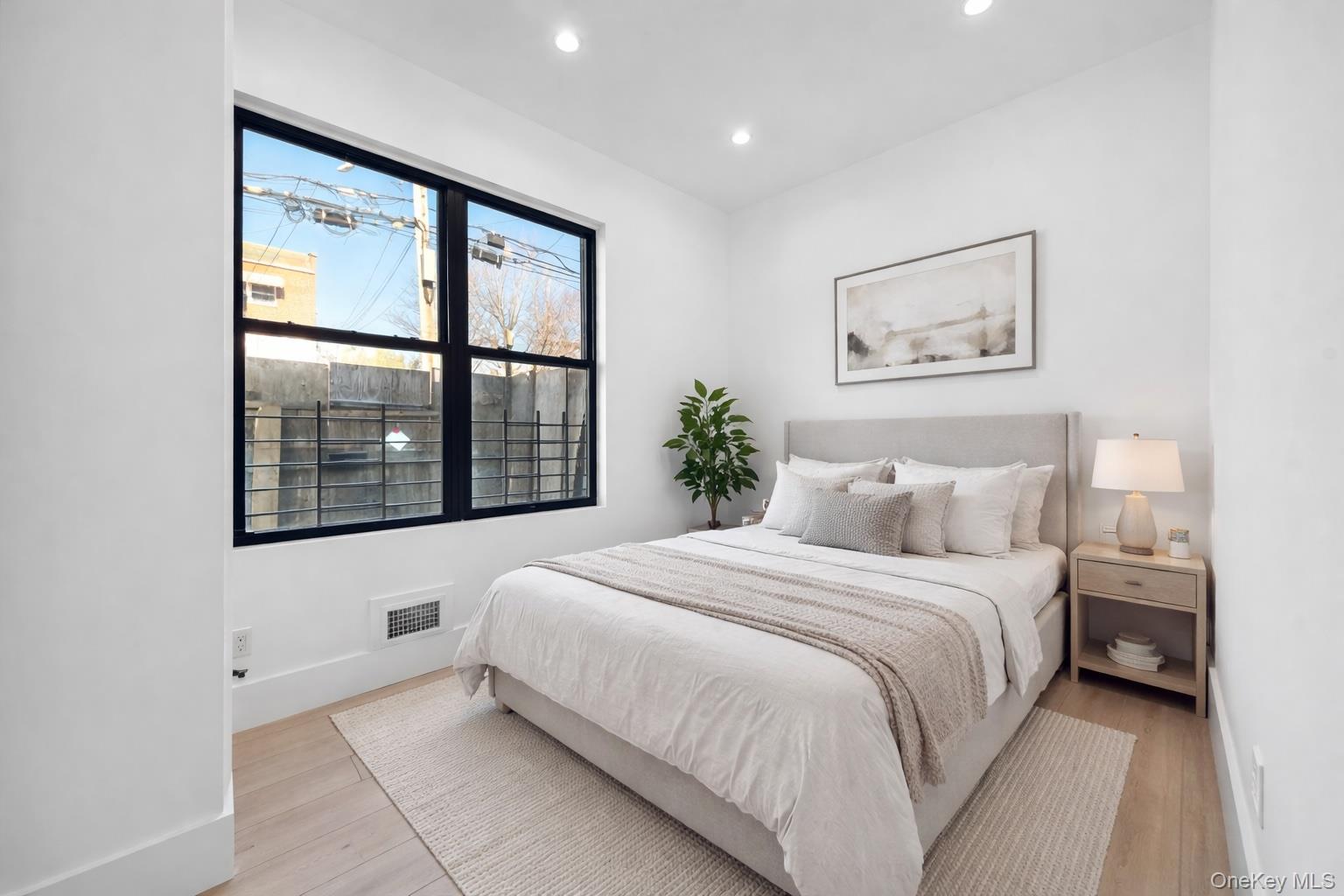 953 Tilden Street Bronx, NY 10469 - Photo 24 of 24 a bedroom with a large bed and a window