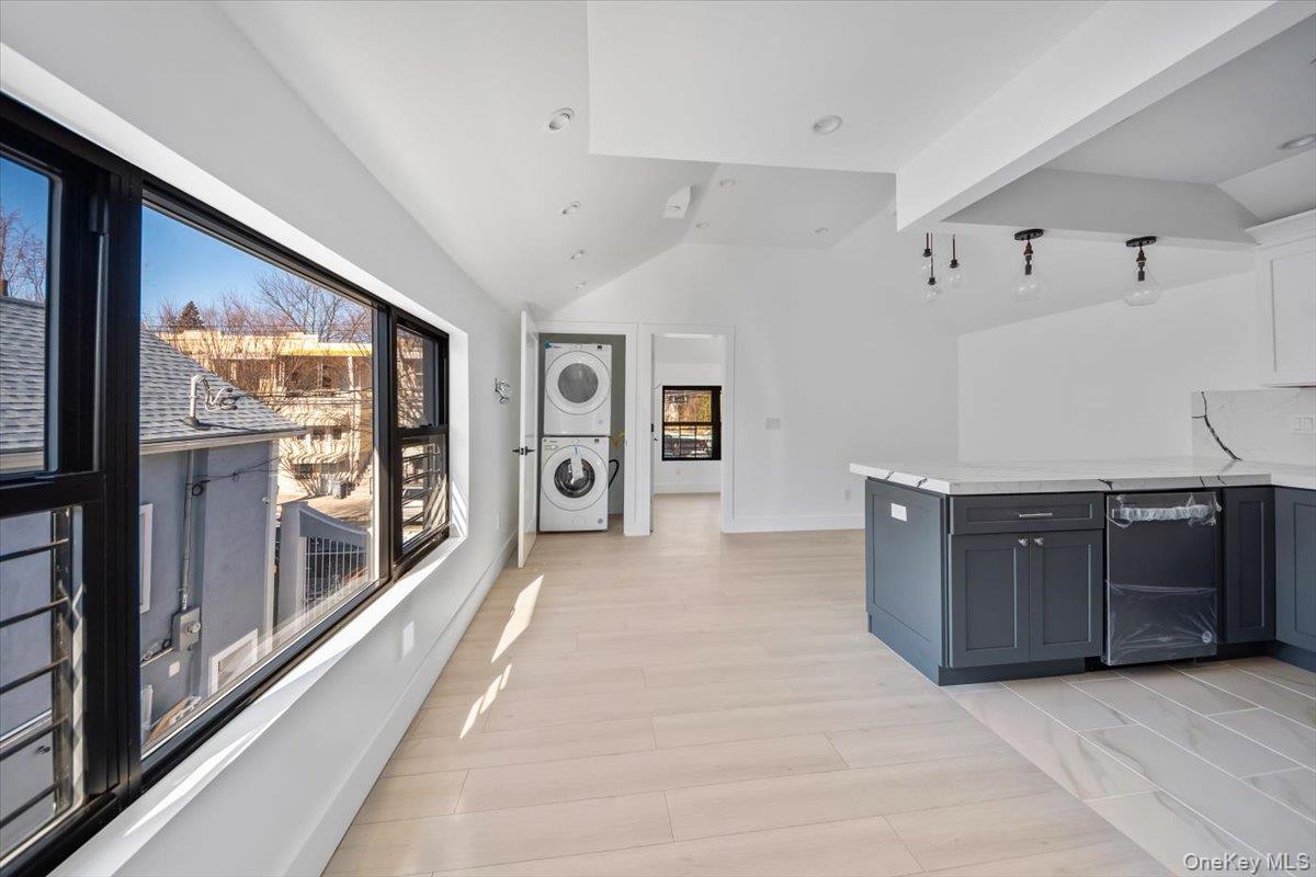 953 Tilden Street Bronx, NY 10469 - Photo 4 of 24 a large kitchen with stainless steel appliances granite countertop a refrigerator and a stove
