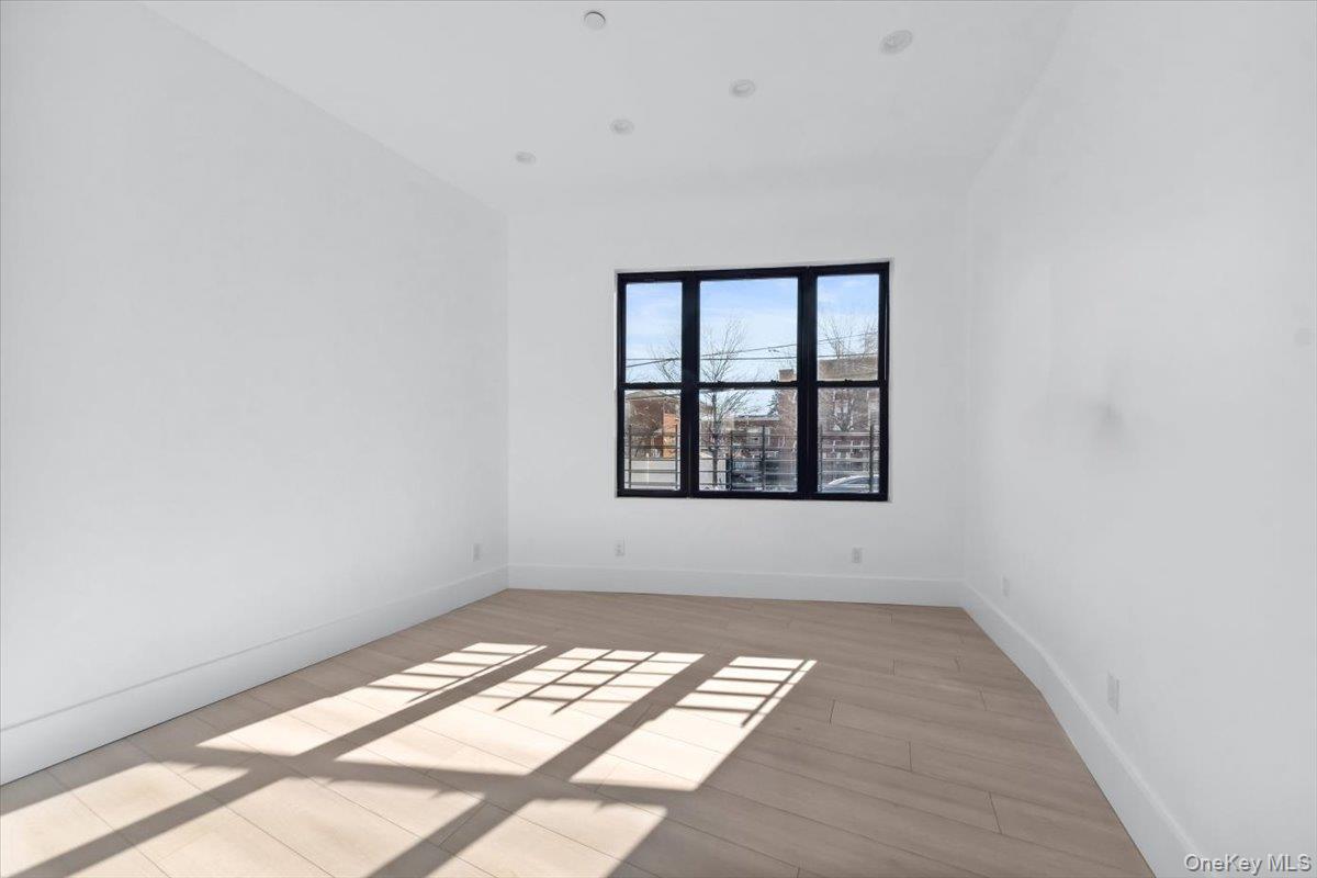 953 Tilden Street Bronx, NY 10469 - Photo 9 of 24 an empty room with windows