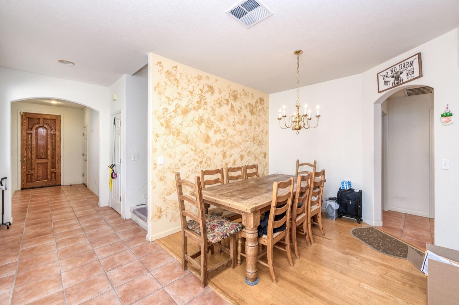 2661 Buckingham Avenue Clovis, CA 93611 - Photo 18 of 50 a view of a dining room with furniture and a chandelier