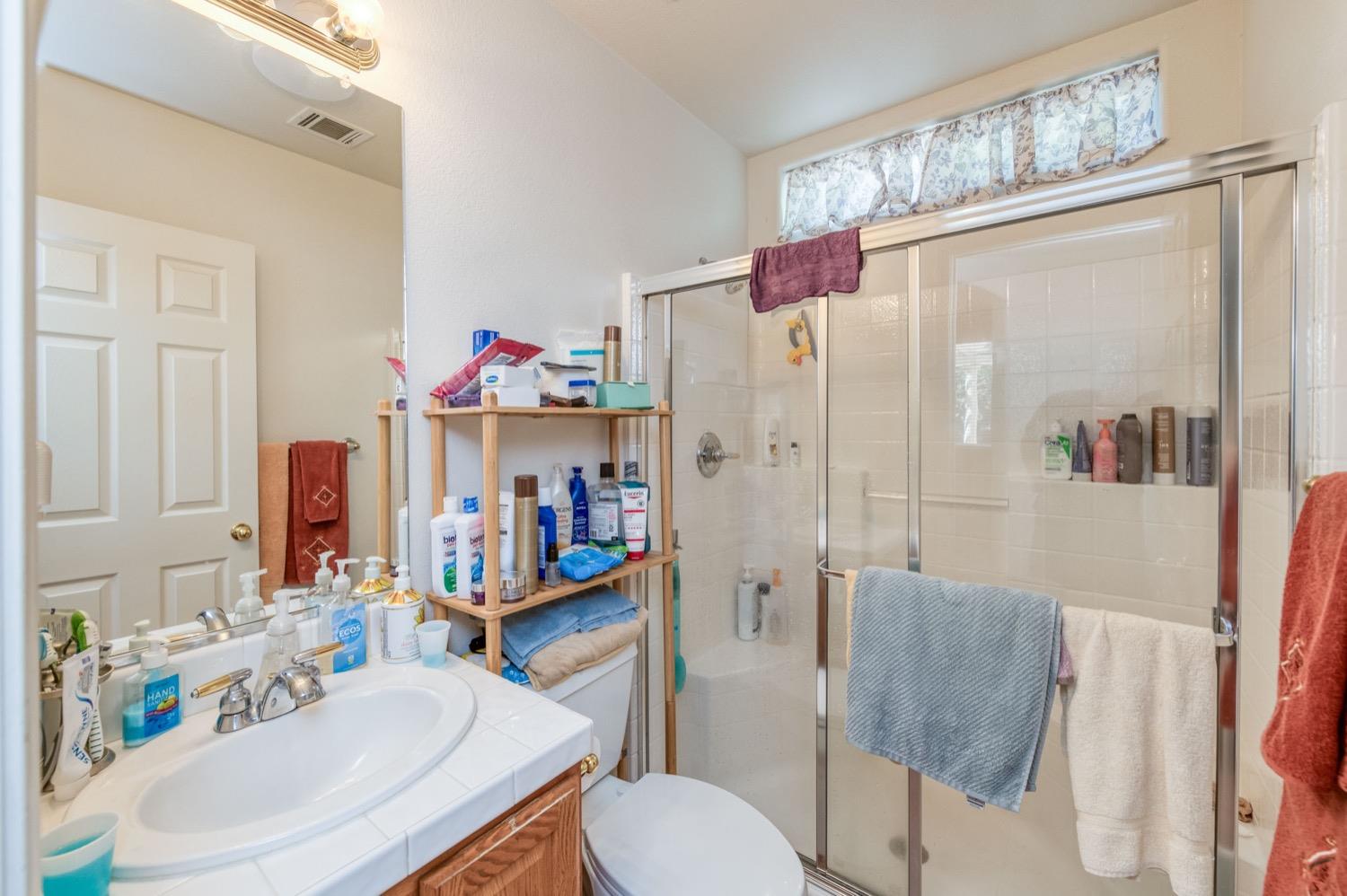 2661 Buckingham Avenue Clovis, CA 93611 - Photo 20 of 50 a bathroom with a sink toilet and shower