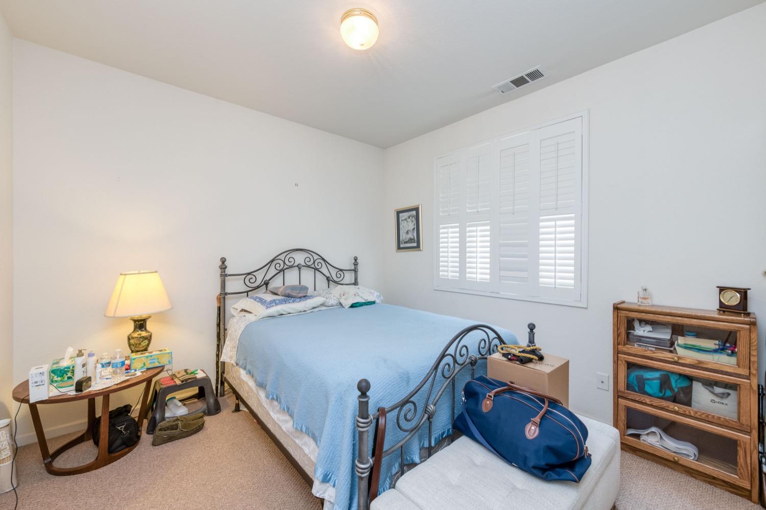 2661 Buckingham Avenue Clovis, CA 93611 - Photo 21 of 50 a bedroom with a bed and a window