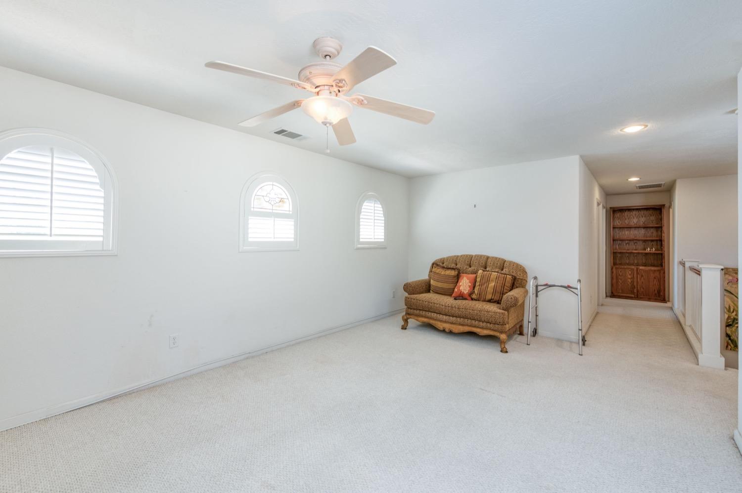2661 Buckingham Avenue Clovis, CA 93611 - Photo 24 of 50 an empty room with windows and ceiling fan