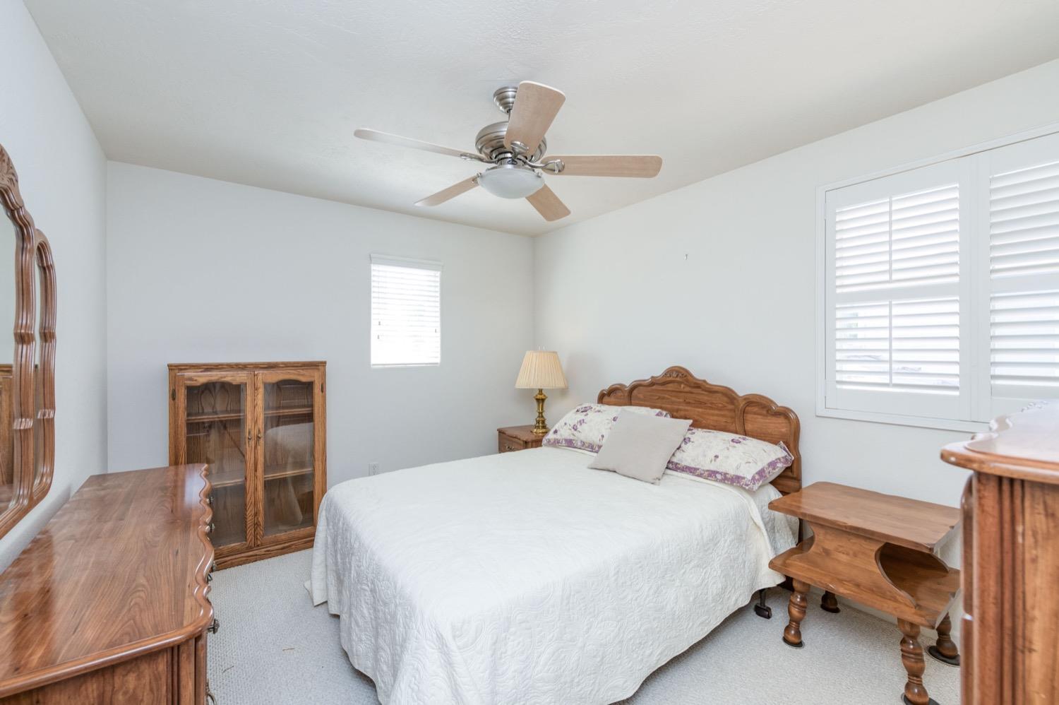 2661 Buckingham Avenue Clovis, CA 93611 - Photo 27 of 50 a bedroom with a bed and a chandelier