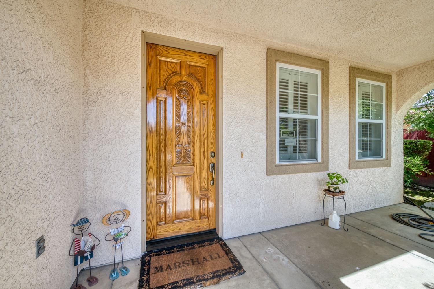 2661 Buckingham Avenue Clovis, CA 93611 - Photo 3 of 50 a view of an entryway with wooden floor and a potted plant