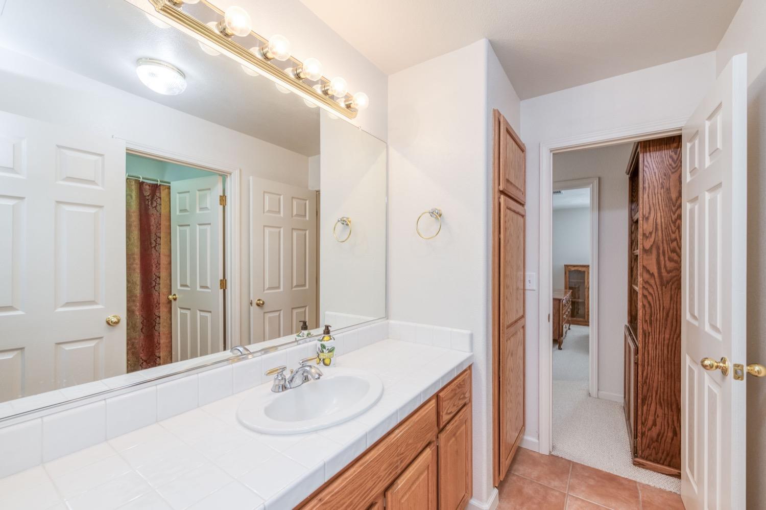 2661 Buckingham Avenue Clovis, CA 93611 - Photo 32 of 50 a bathroom with a sink double vanity and a mirror