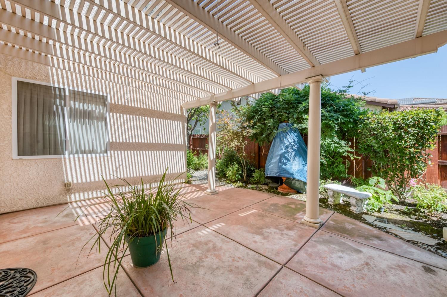 2661 Buckingham Avenue Clovis, CA 93611 - Photo 39 of 50 a view of a patio with table and chairs potted plants with wooden floor
