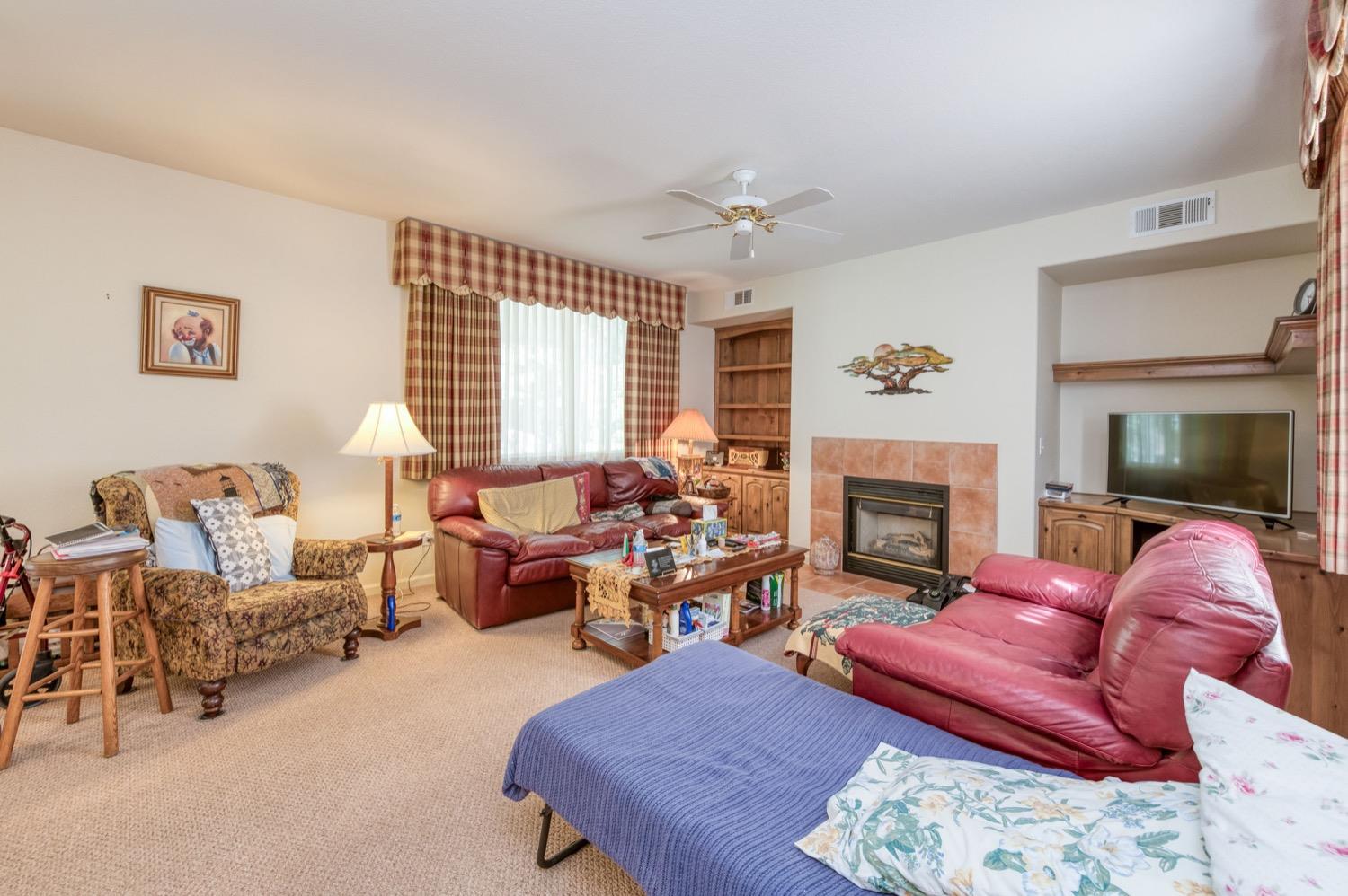 2661 Buckingham Avenue Clovis, CA 93611 - Photo 8 of 50 a living room with furniture fireplace and window