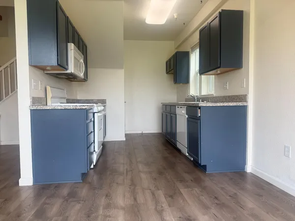a kitchen with stainless steel appliances granite countertop a stove and a sink