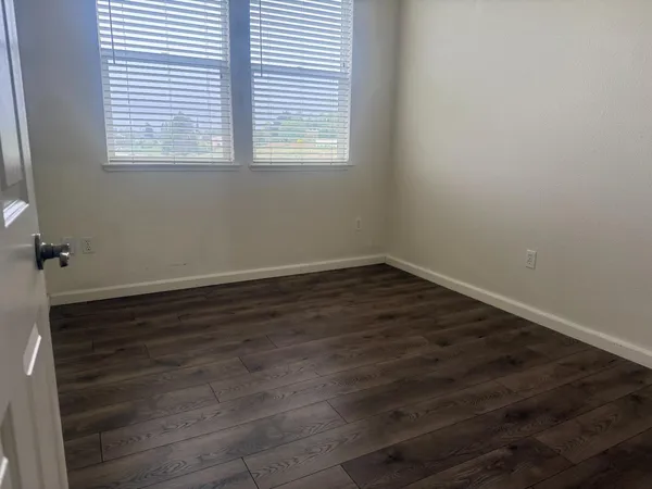 wooden floor and window in an empty room