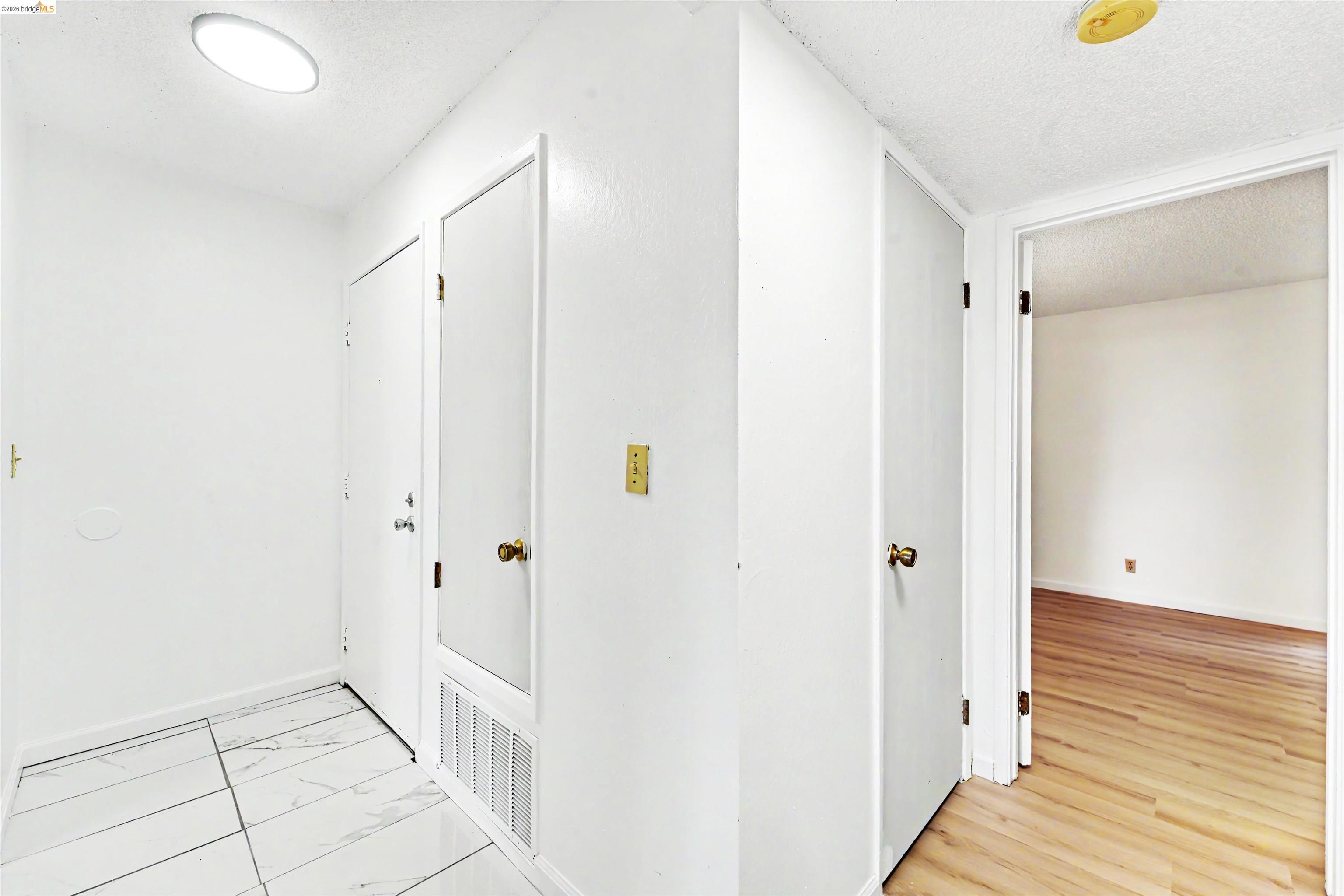4186 San Pablo Dam Road, Unit A El Sobrante, CA 94803 - Photo 27 of 34 Entryway featuring white tile flooring, flush-mount ceiling lighting, and a white interior door with brass hardware