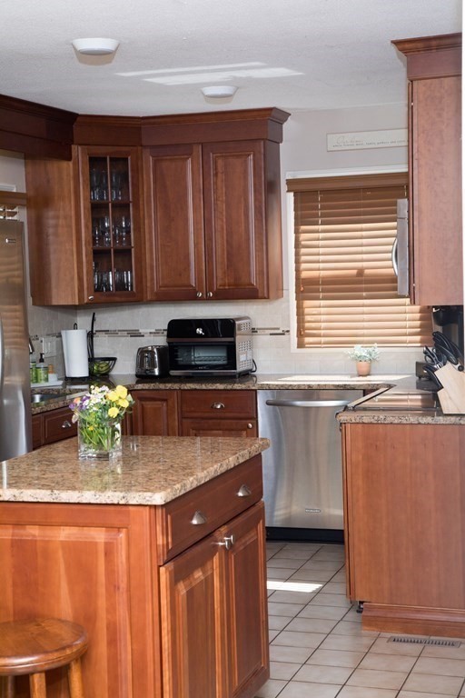 22 Deer Run Road West Springfield, MA 01089 - Photo 5 of 38 a kitchen with stainless steel appliances granite countertop a stove a sink a microwave and wooden cabinets