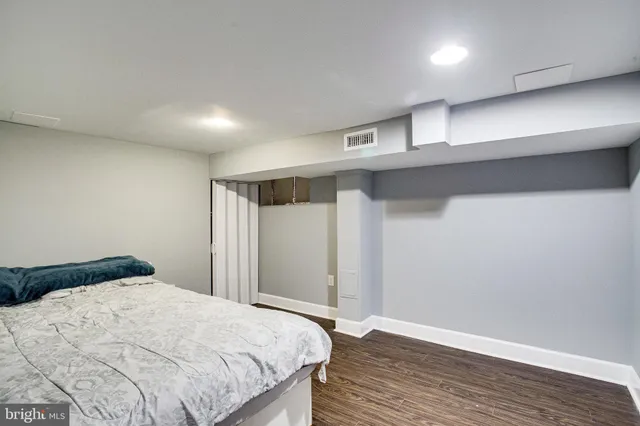 a living room with furniture a fireplace and wooden floor