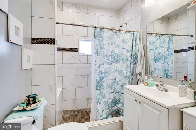 a large kitchen with a counter space a sink and stainless steel appliances