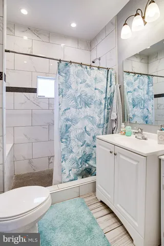 a large kitchen with a refrigerator and wooden cabinets