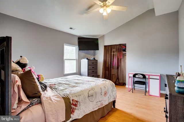 a utility room with a sink and wooden floor