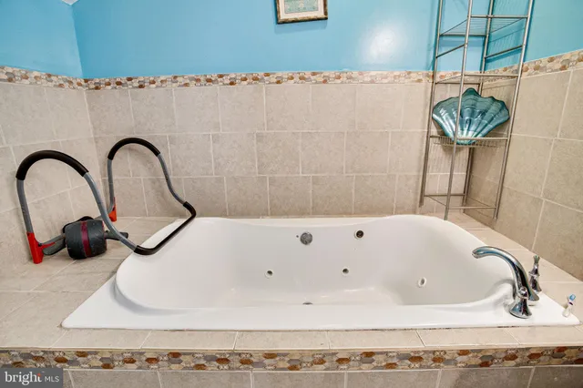 a bedroom with a bed and a dresser in it