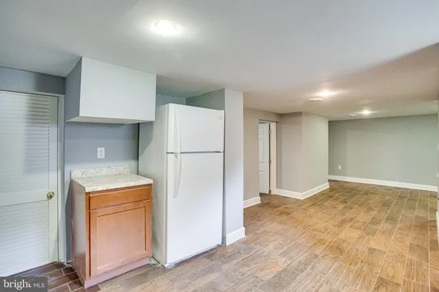 a bathroom with a granite countertop sink a mirror and a toilet