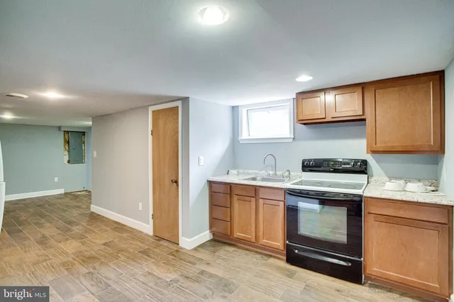 a bathroom with a granite countertop toilet sink and mirror