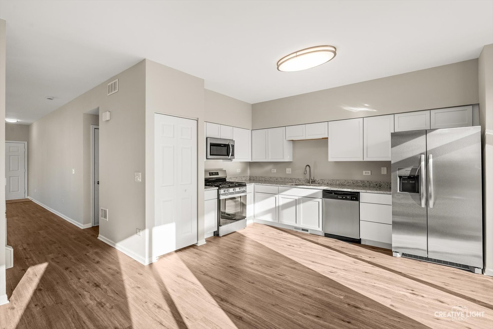 308 Alyssa Street Plano, IL 60545 - Photo 4 of 10 a kitchen with granite countertop a refrigerator and a sink