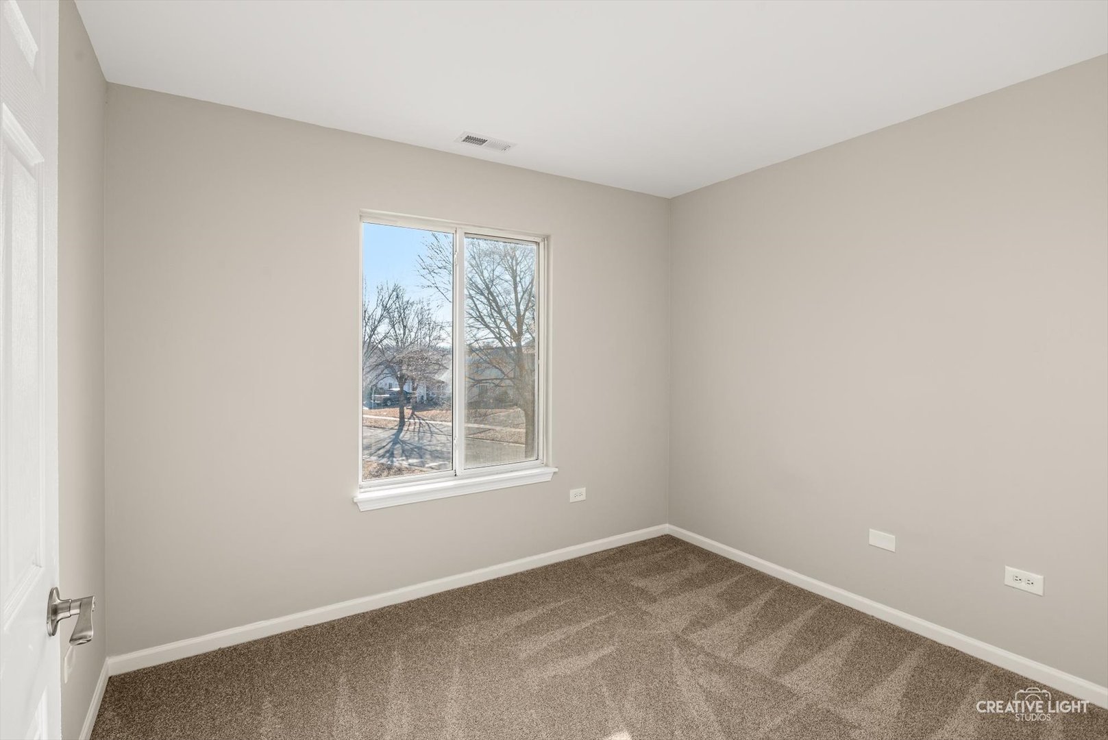 308 Alyssa Street Plano, IL 60545 - Photo 5 of 10 an empty room with a window