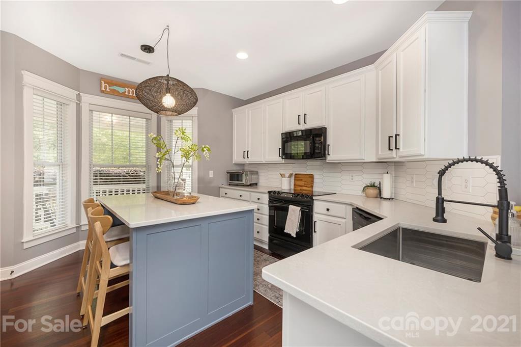13524 Stumptown Road Huntersville, NC 28078 - Photo 2 of 26 a kitchen with a sink a stove and cabinets