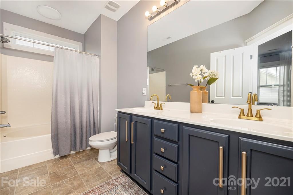 13524 Stumptown Road Huntersville, NC 28078 - Photo 11 of 26 a bathroom with a double vanity sink toilet and a tub