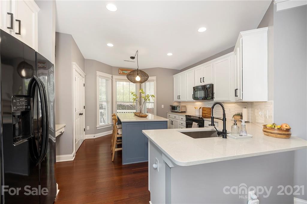 13524 Stumptown Road Huntersville, NC 28078 - Photo 4 of 26 a kitchen with a sink a counter top space stainless steel appliances and cabinets