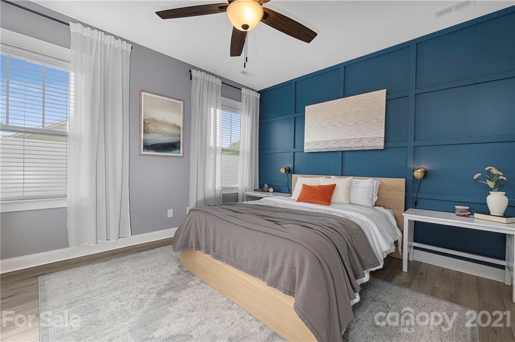 13524 Stumptown Road Huntersville, NC 28078 - Photo 10 of 26 a bedroom with a bed and a chandelier