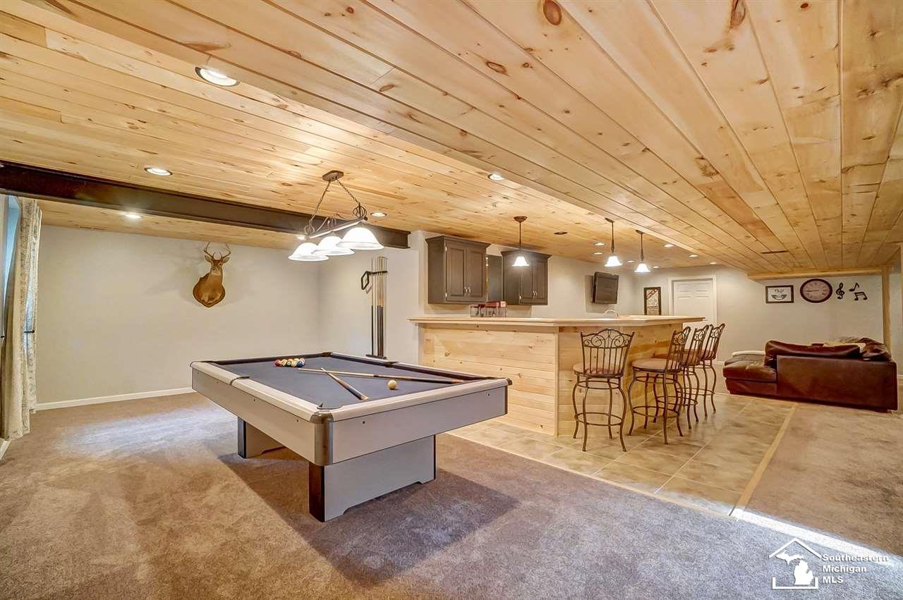 6475 Douglas Road Lambertville, MI 48144 - Photo 25 of 39 Newly finished full basement features two egress windows, a recreation area, wet bar, second living space, home office space, 4th bedroom, full bathroom as well as 2 unfinished storage areas and stora