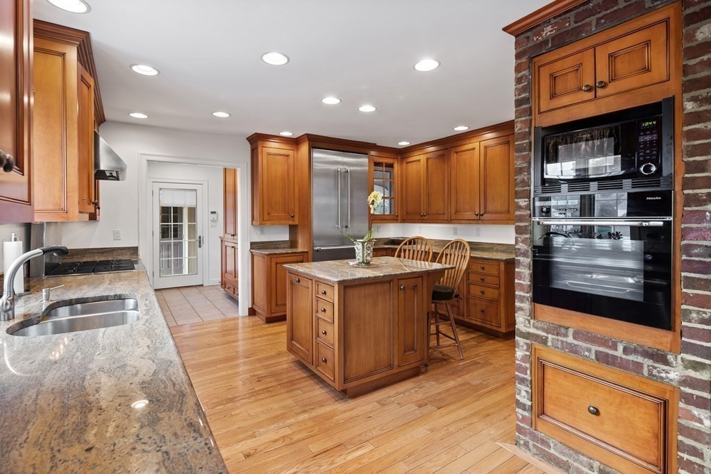 32 Hidden Road Andover, MA 01810 - Photo 14 of 34 a kitchen with stainless steel appliances granite countertop a stove a sink and a refrigerator
