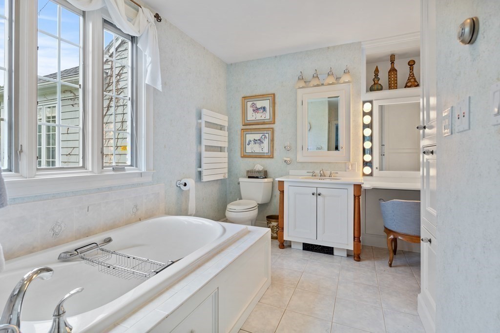 32 Hidden Road Andover, MA 01810 - Photo 23 of 34 a bathroom with a granite countertop sink and a large mirror