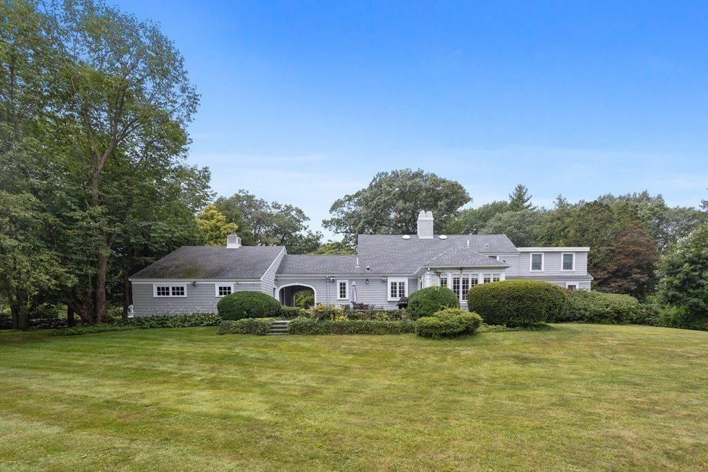 32 Hidden Road Andover, MA 01810 - Photo 10 of 34 a front view of a house with a garden and tree
