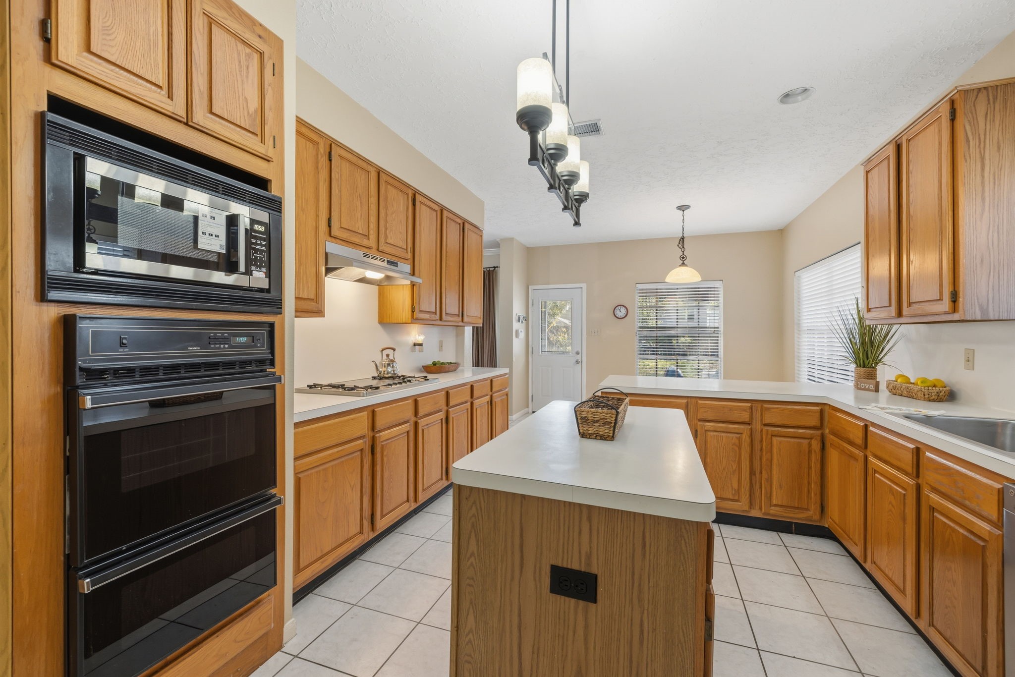 8403 Northbridge Drive Spring, TX 77379 - Photo 15 of 50 a kitchen with stainless steel appliances granite countertop a sink and stove top oven