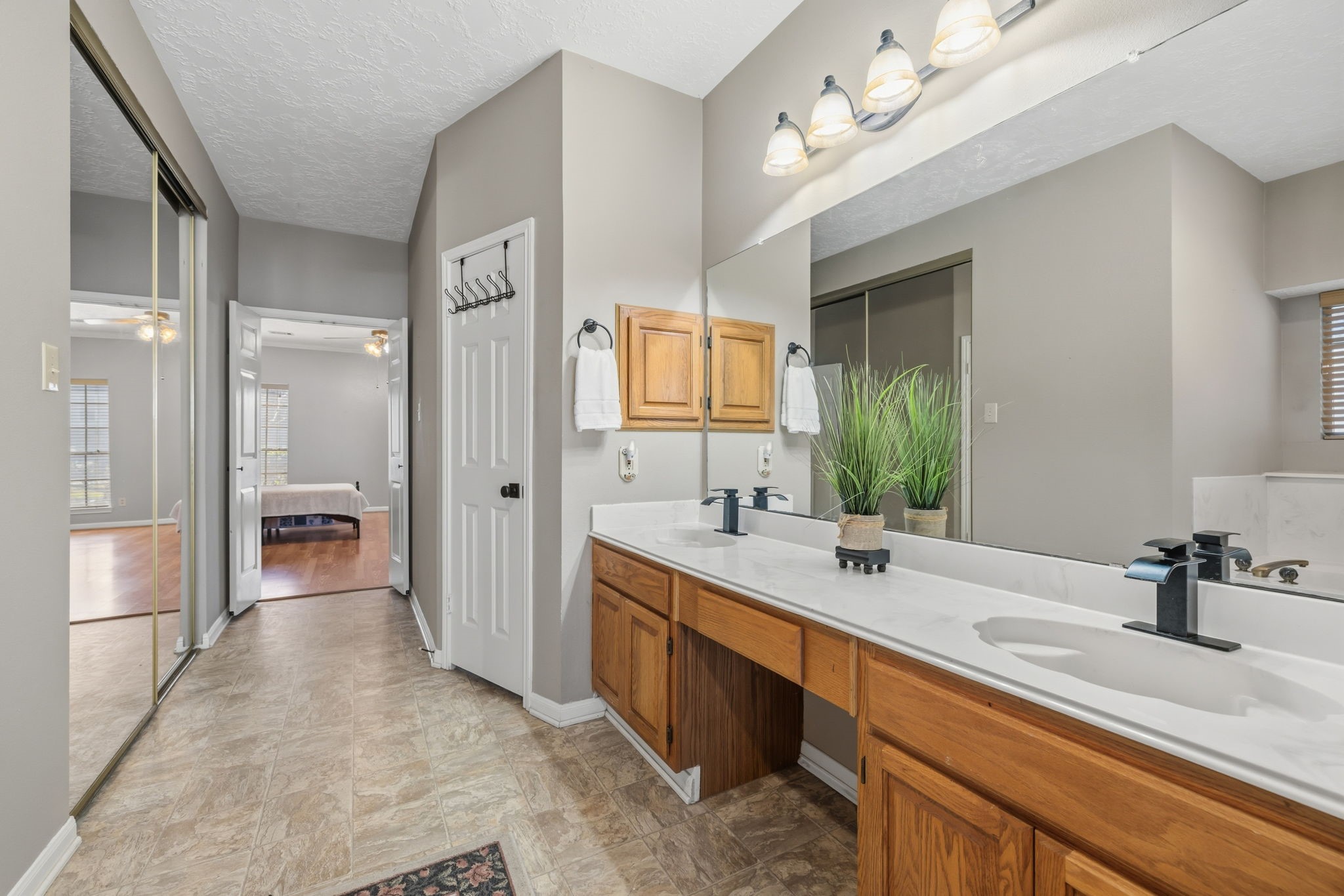 8403 Northbridge Drive Spring, TX 77379 - Photo 23 of 50 a bathroom with a sink double vanity granite tub shower and a mirror
