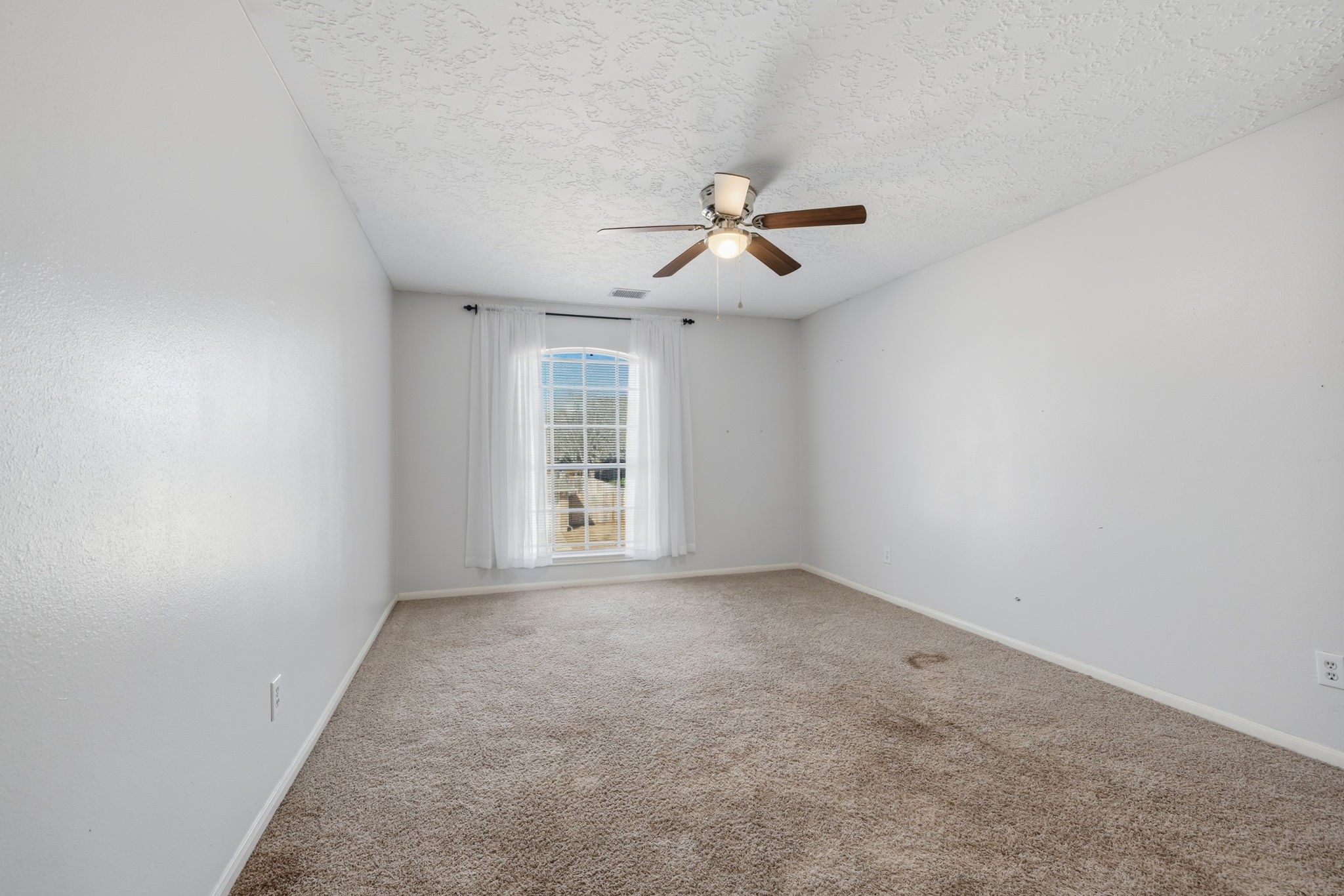 8403 Northbridge Drive Spring, TX 77379 - Photo 25 of 50 a view of room with a ceiling fan and window