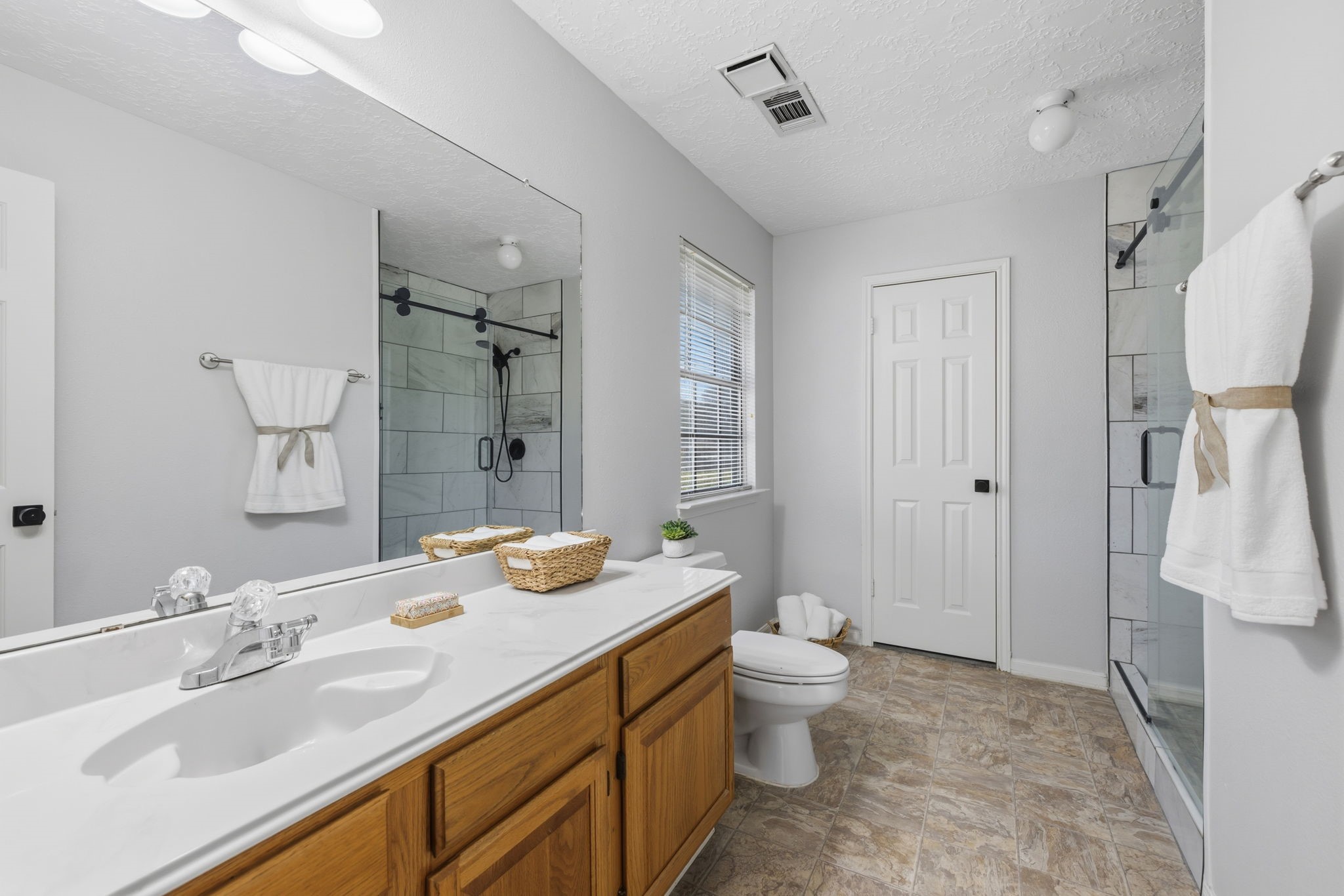 8403 Northbridge Drive Spring, TX 77379 - Photo 27 of 50 a bathroom with a granite countertop sink toilet and shower