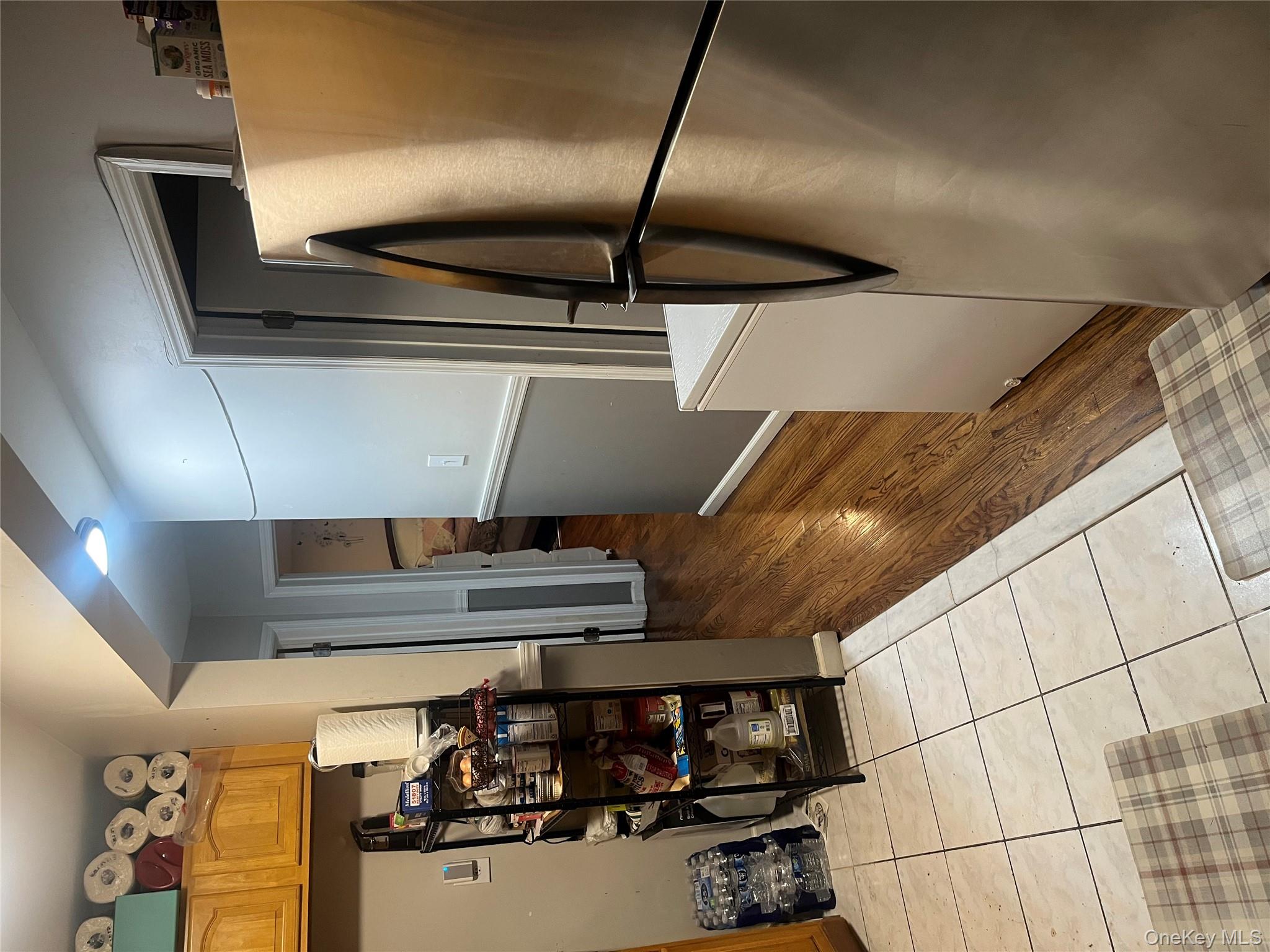 137-15 220th Place Queens, NY 11413 - Photo 13 of 28 a kitchen with stainless steel appliances granite countertop a refrigerator and a sink