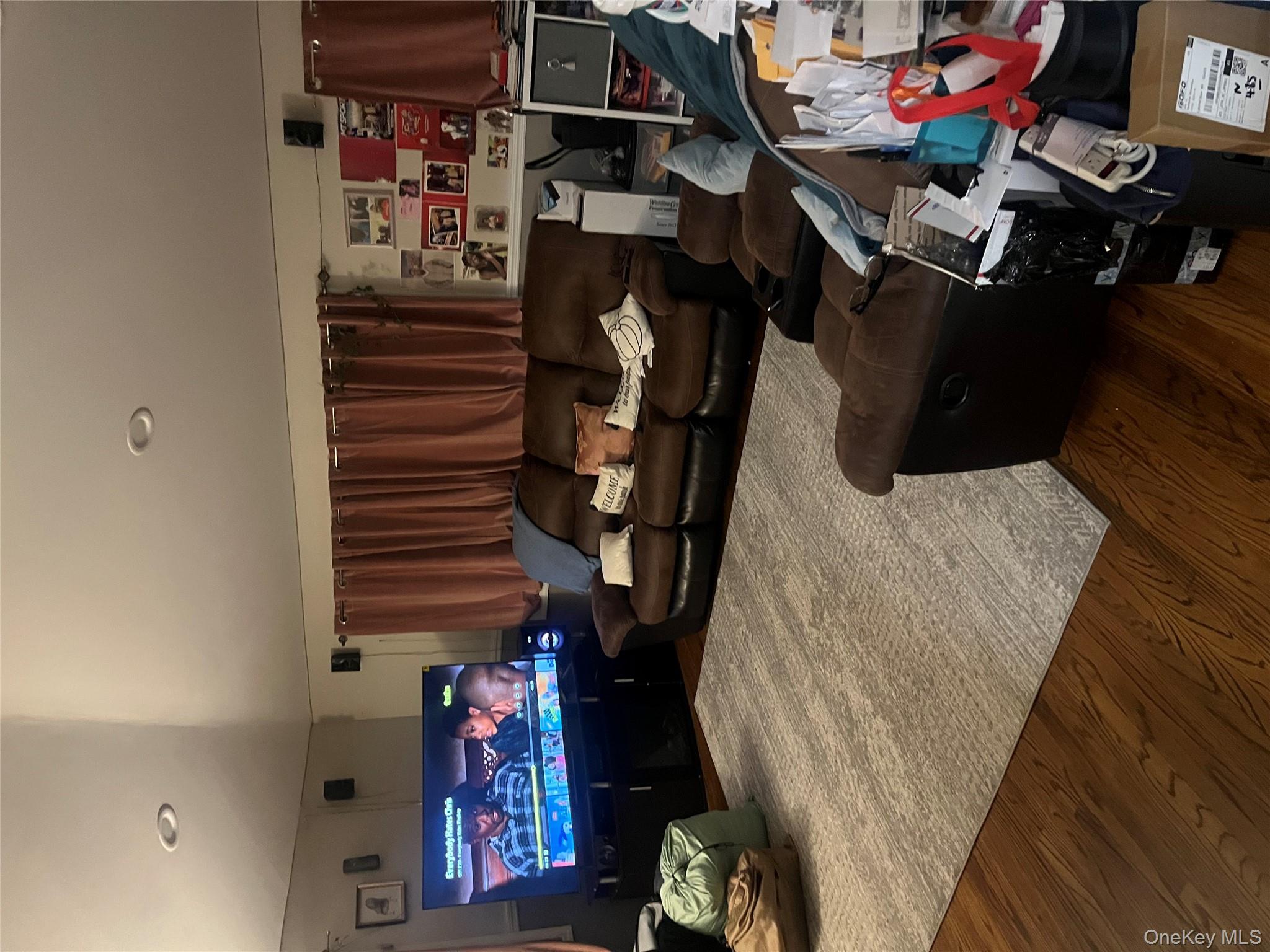 137-15 220th Place Queens, NY 11413 - Photo 15 of 28 a room with furniture and a wooden floor